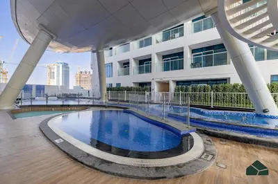 a swimming pool on the roof of a building at Peaceful Studio in Opalz by Danube by BMS in Dubai