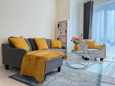 a living room with a couch and a glass table at Cozy apartment in Dubai Marina - Torch Tower in Dubai
