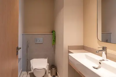 a bathroom with a toilet and a sink and a mirror at HAVN - 2 Bed Burj Khalifa View, Access Dubai Mall in Dubai