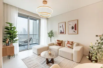 a living room with a couch and a table at HAVN - 2 Bed Burj Khalifa View, Access Dubai Mall in Dubai