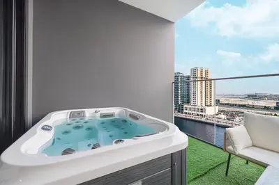 a hot tub on a balcony with a view at Binghatti Trillionaire! 2 Double Beds! Private Jacuzzi, Prime Location! in Dubai