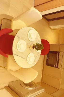 a table with plates on it in a kitchen at Azizi in Dubai