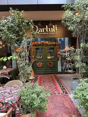 a store front with a green door with flowers and plants at Fabulous 1 bed apartment within walking distance to Dubai mail and Burj Khalifa in Dubai