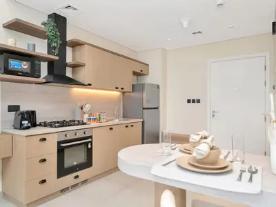 a kitchen with a table with a plate on it at Stylish 1-Bedroom in Collective 2 - Dubai Hills in Dubai