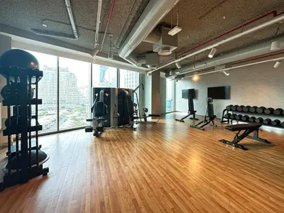 a gym with a hard wood floor and a large window at Burj Khalifa View From The Infinity Pool 2BR at Downtown Dubai in Dubai