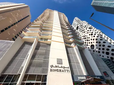 a tall building in the middle of two buildings at PVH - Canal Frontage 1BR - Millennium Binghatti in Dubai