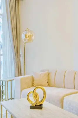 a living room with a gold snake on a table at PVH - Canal Frontage 1BR - Millennium Binghatti in Dubai
