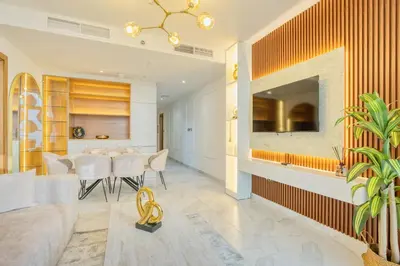 a dining room and living room with a fireplace at PVH - Canal Frontage 1BR - Millennium Binghatti in Dubai