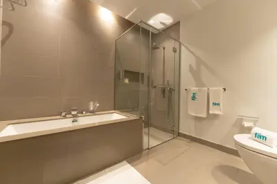 a bathroom with a shower and a sink and a toilet at Chic 2Bedroom And Maids Room Apartment Mins from Dubai Mall in Dubai