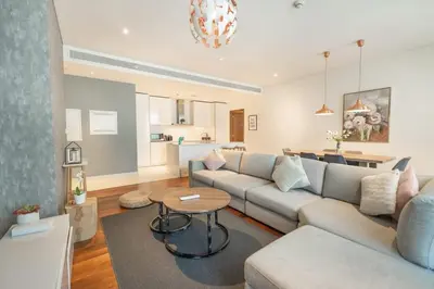 a living room with a couch and a table at Spacious Two Bedroom with Maids room Near City Mall in Dubai
