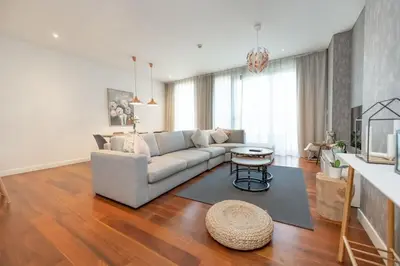a living room with a couch and a table at Spacious Two Bedroom with Maids room Near City Mall in Dubai