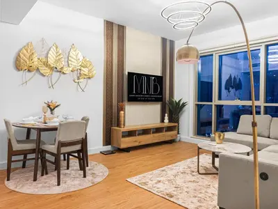 a living room with a table and a couch at Cozy 1BR Downtown Burj View in Dubai