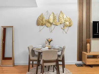 a dining room with a table with chairs and a mirror at Cozy 1BR Downtown Burj View in Dubai