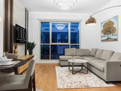 a living room with a couch and a table at Cozy 1BR Downtown Burj View in Dubai