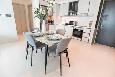 a dining room table and chairs in a kitchen at Elegant 1BR at Sunrise Bay with Stunning Palm View in Dubai