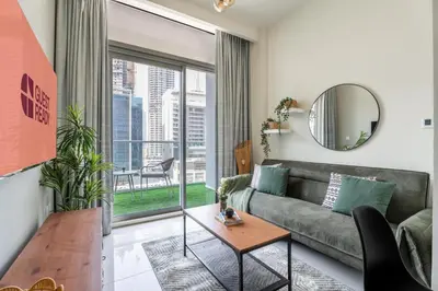 a living room with a couch and a table at GuestReady - 1BR l Stylish City Escape in Dubai