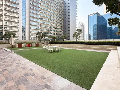 a lawn with tables and chairs in a building at GuestReady - 1BR l Stylish City Escape in Dubai