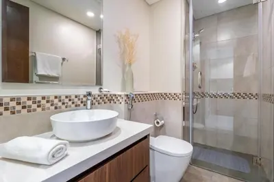 a bathroom with a sink and a toilet and a shower at GuestReady - 1BR l Stylish City Escape in Dubai