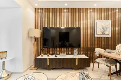 a living room with a table and a television at Bright 1BR Apartment in Elite Residence Marina in Dubai