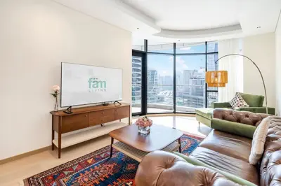 a living room with a couch and a flat screen tv at Urban 1BR Retreat RP Heights Near Dubai Mall in Dubai