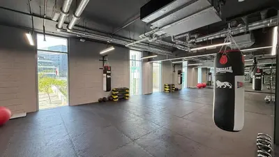 a room with a skateboard hanging from a wall at Burj Daman By Luxe Living - Future Museum & Emirates Towers Views in Dubai
