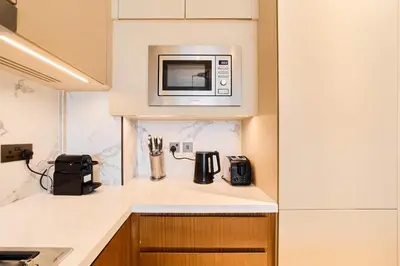 a kitchen with a microwave above a counter at Premium 2BR Address Opera Downtown Dubai in Dubai