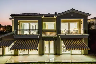 a house with balconies on the side of it at Exclusive Golf Villa 5BR with Pool and Game Room in Dubai