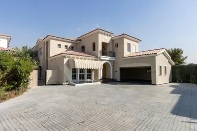 a large house with a large driveway at Exclusive Golf Villa 5BR with Pool and Game Room in Dubai