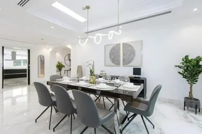 a dining room with a table and chairs at Exclusive Golf Villa 5BR with Pool and Game Room in Dubai