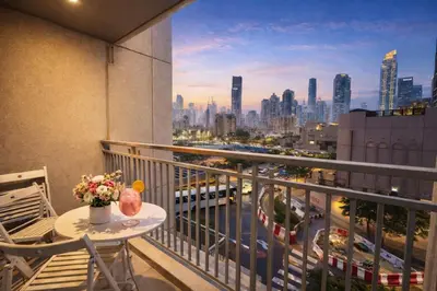a balcony with a table and a view of a city at Luxury 1BR Apartment at Burj Views Tower C - Downtown in Dubai