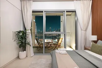 a bedroom with a bed and a view of the city at Luxurious 2 bedroom with Burj Khalifa views, connected to Dubai Mall in Dubai