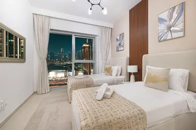 a hotel room with two beds and a window at Luxurious 2 bedroom with Burj Khalifa views, connected to Dubai Mall in Dubai