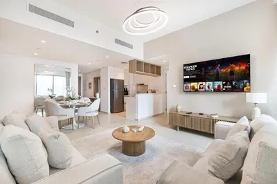 a living room with two couches and a dining room at Luxurious 2 bedroom with Burj Khalifa views, connected to Dubai Mall in Dubai