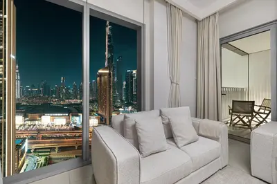 a living room with a couch and a view of a city at Luxurious 2 bedroom with Burj Khalifa views, connected to Dubai Mall in Dubai