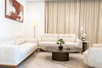 a living room with two white couches and a table at Morden 2BR With Full sea view -High floor in Dubai