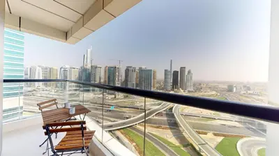 two chairs on a balcony with a view of a city at Locations l Elegant 1 Bedroom l Skyline Views l Dubai Marina in Dubai