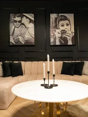 a living room with a couch and a table with candles at Fountain view Golden Era Cinema-Inspired 4BR APT in Dubai