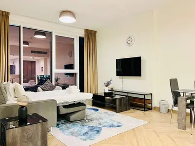a living room with a couch and a tv at Skyline 19 1 Residences in Dubai