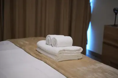 a pile of towels sitting on top of a bed at Skyline 19 1 Residences in Dubai