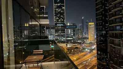 a view of a city at night from a building at Skyline 19 1 Residences in Dubai