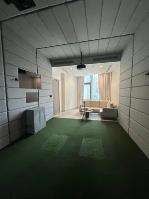a living room with a couch and a green carpet at Luxury 1Bed at LIV Marina Stunning Marina Views in Dubai
