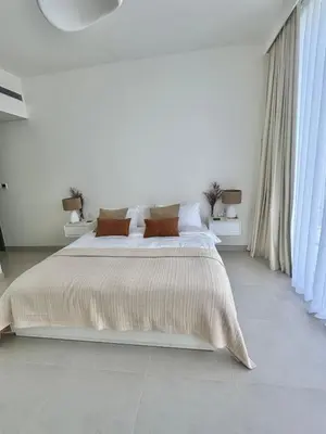a white bedroom with a large bed with pillows at Luxury 1Bed at LIV Marina Stunning Marina Views in Dubai