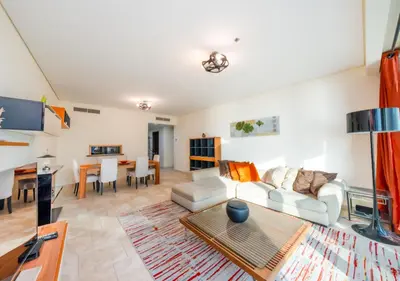 a living room with a couch and a table at JBR High Floor 2BR Stunning Ain Dubai View in Dubai