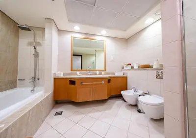 a bathroom with a tub and a toilet and a sink at JBR High Floor 2BR Stunning Ain Dubai View in Dubai