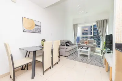 a living room with a table and a couch at Modern 1BR -Canal Views & Burj Views -Business Bay in Dubai