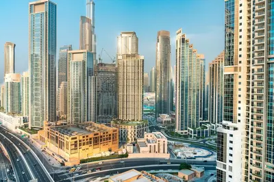 an aerial view of a city with tall buildings at 2BR With Rooftop Pool Offering Burj Khalifa Views in Dubai