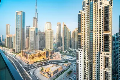 an aerial view of a city with tall buildings at 2BR With Rooftop Pool Offering Burj Khalifa Views in Dubai