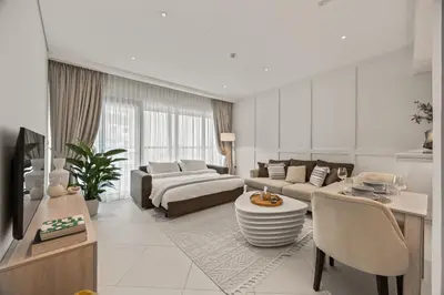 a living room with a couch and a table at Palm Jumeirah Sea-View Stay - Infinity Pool - Beach - Gym - Padel in Dubai