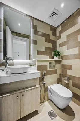 a bathroom with a toilet and a sink and a mirror at Palm Jumeirah Sea-View Stay - Infinity Pool - Beach - Gym - Padel in Dubai