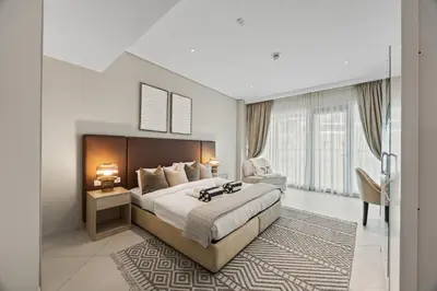 a bedroom with a large bed and a large window at Palm Jumeirah Sea-View Stay - Infinity Pool - Beach - Gym - Padel in Dubai